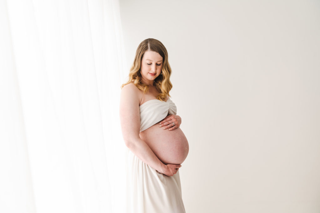 pregnant woman holding belly